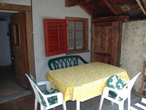 a bedroom with a bed and two chairs and a window at Chalet in M rel with Terrace Parking Garden Furniture in Mörel