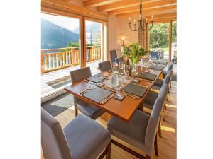 a dining room with a long table and chairs at Unique holiday home in H r mence in the ski area in Hérémence