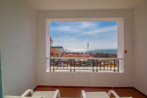 a window in a room with a view of a balcony at Qingdao Seaview Garden Hotel in Qingdao