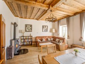 a living room with a couch and a wood stove at Holiday home in Obervellach near ski area in Obervellach