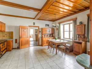 a kitchen with wooden cabinets and a table with chairs at Holiday home in Obervellach near ski area in Obervellach