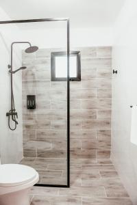 a bathroom with a shower and a toilet at Boho Twin Villa 35 in Punta Cana