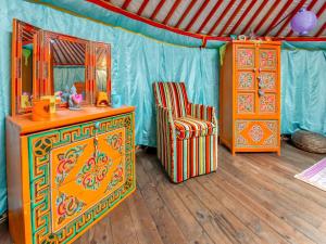 a room with a mirror and a chair in a tent at Lively Holiday Home with Garden Barbecue Garden Furniture in Houffalize