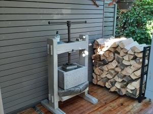 a wood stove sitting next to a pile of logs at Cottage in Durbuy with Terrace Garden Barbecue in Durbuy
