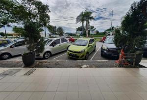 a group of cars parked in a parking lot at Highway Budget Hotel in Ipoh