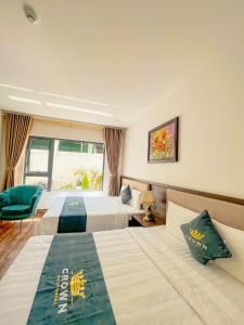 Voodi või voodid majutusasutuse Crown Dalat Hotel toas