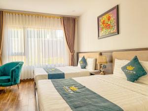 Voodi või voodid majutusasutuse Crown Dalat Hotel toas