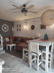 a living room with a table and a couch at DEPAR DE PLAYA Casa Blanca Same in Same