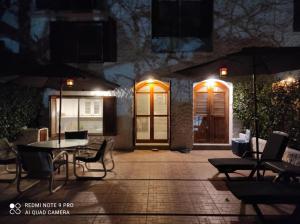 a patio with a table and chairs at night at DEPAR DE PLAYA Casa Blanca Same in Same