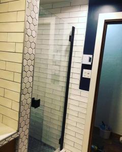 a bathroom with a shower with a glass door at Knotty Pine Lodge in Golden