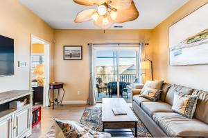 a living room with a couch and a tv at Villas at Bay Crossing - 34670 Villa Circle Unit #2304 in Lewes