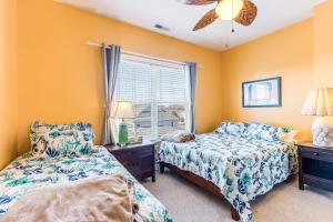 a bedroom with two beds and a window at Villas at Bay Crossing - 34670 Villa Circle Unit #2304 in Lewes
