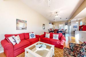 a living room with a red couch and a table at Smiles N Waves in Panama City Beach