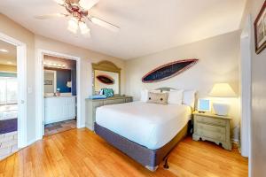 a bedroom with a bed and a ceiling fan at Smiles N Waves in Panama City Beach +34 photos
