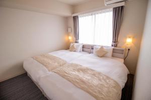 Postel nebo postele na pokoji v ubytování Framboise KYOTO Hotel de charme