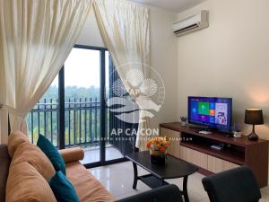 a living room with a couch and a large window at Swiss Garden Resort Residences Kuantan by AP CA CON in Kampung Sungai Karang