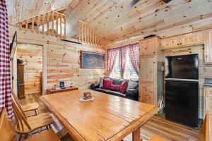 a dining room and living room with a wooden table at Meandering Moose Cabin in Florissant
