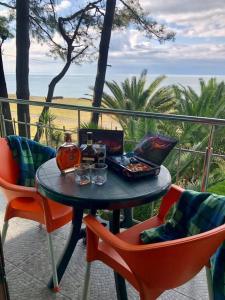 a table and chairs on a patio with a view of the ocean at Shekvetili Green House in Shekvetili