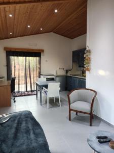 a kitchen and living room with a table and chairs at Wooden House in Paphos City