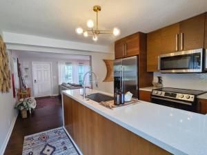 a kitchen with a white counter top and wooden cabinets at The Place in Fort Lauderdale