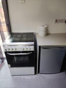 a kitchen with a stove and a counter top at Wooden House in Paphos City