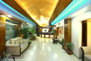 a lobby with couches and a table in a building at Dhaka Golden Inn - Banani'Lakeside in Dhaka