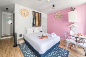 a bedroom with a large bed and a table at Apartments WS Opéra - Galeries Lafayette in Paris