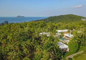 an aerial view of a resort with palm trees and the ocean at Anaia in Thongsala