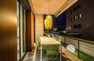 a dining room with a table and chairs on a balcony at Sitges Spaces Garden Paradise 3 bedroom, 3 bathroom, huge PRIVATE garden-terrace, pool- sleeps up to 8 in Sitges