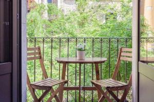 a table and two chairs on a balcony at Sleep y Stay Home with balcony Bonaventura 3 in Girona