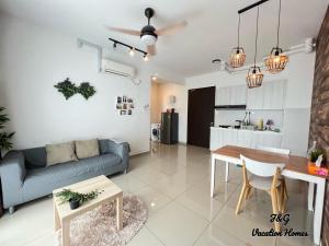 a living room with a couch and a table at The Garden By J&G Vacation Homes in Skudai