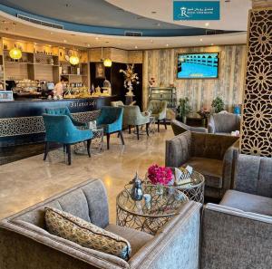 a lobby of a hotel with couches and a bar at Royal View Hotel in Ras al Khaimah