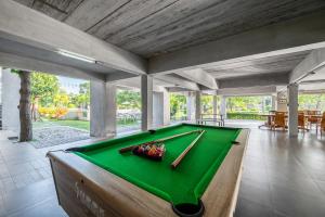 a pool table in the middle of a room at Pirom Garden Private Villa in Pattaya North
