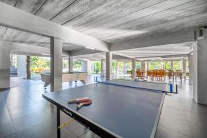 a ping pong table with a pair of scissors on it at Pirom Garden Private Villa in North Pattaya