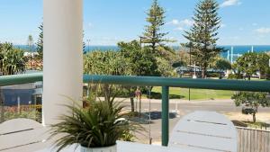 a balcony with chairs and a view of a parking lot at Unit 2 'fair Haven' Kings Beach in Caloundra