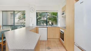a kitchen with a white counter top and a window at Unit 2 'fair Haven' Kings Beach in Caloundra