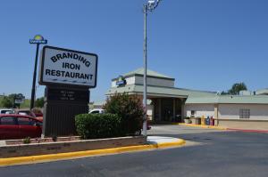 a sign for a gas station in a parking lot at Days Inn by Wyndham Clinton in Clinton