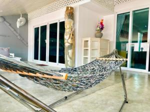 a hammock in the middle of a living room at BE Rendez Vous Hotel in Patong Beach