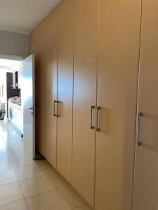 a row of wooden cabinets in a room at Unique luxury beach house in Poros Island in Poros