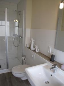 a bathroom with a sink and a toilet and a shower at Strandhotel-Najade in Borkum +34 photos