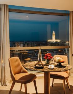 a table and chairs with a view of a city at Idou Anfa Hôtel & Spa in Casablanca