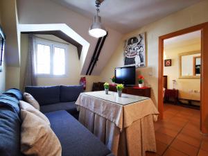 a living room with a couch and a table at IMEDA apartamentos ARTTYCO con parking in Sierra Nevada