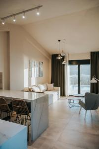 a living room with a couch and a table at Elia Luxury Suites in Plataria