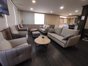 a living room with couches and chairs and a table at Hotel Querol in Valderrobres