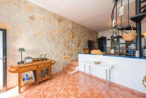 a living room with a counter and a table at Vista Faro Sardina in Las Palmas de Gran Canaria