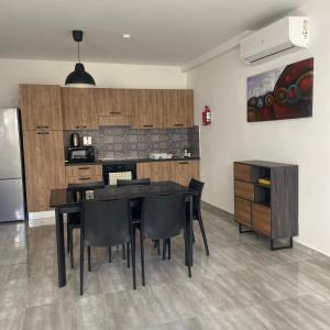 a kitchen with a table and chairs and a refrigerator at F7-1 Double room with private bathroom in shared Flat in Msida