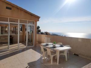 a table and chairs on a balcony with the ocean at Nautic Vista Mar Orangecosta in Peniscola