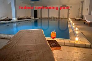 a swimming pool with a glass of wine next to it at Appartamento 5 stelle Barcola - 50 meters from the sea in Trieste
