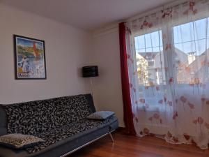 a living room with a couch and a window at Turgot in Thonon-les-Bains