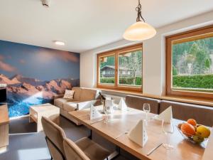 a dining room with a table and a couch at Apartment in Wald near Zillertal Ski Slopes in Wald im Pinzgau